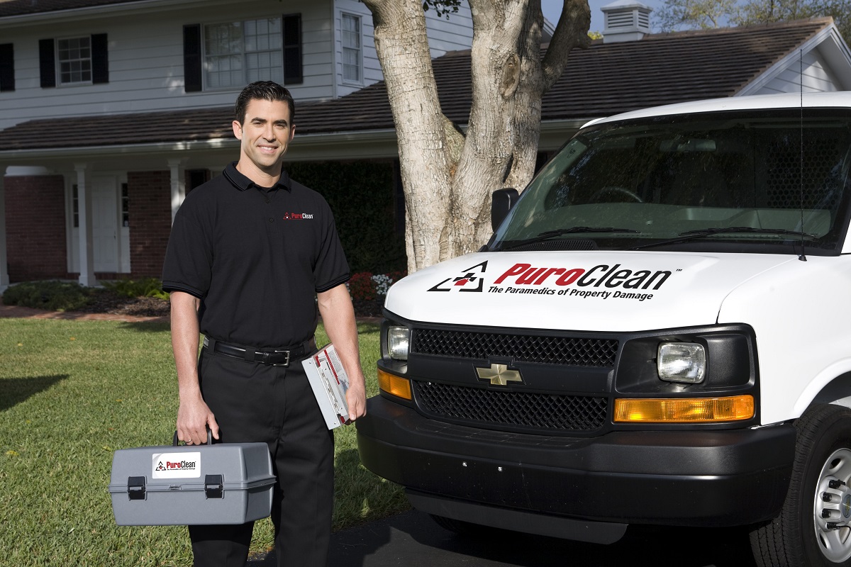 PuroClean restoration technician with service van